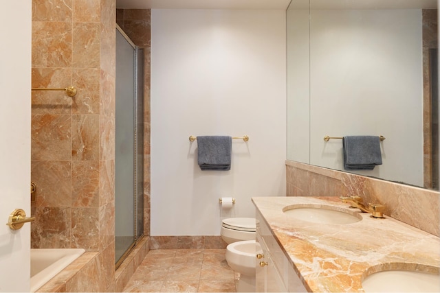 full bathroom featuring a bidet, a sink, a shower stall, and toilet