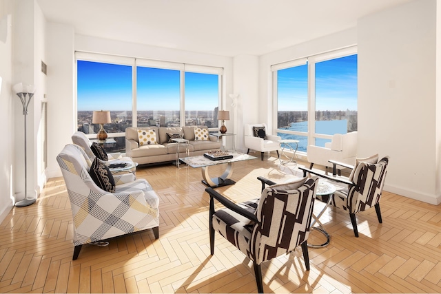 living room with a water view and baseboards