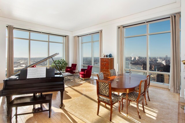 dining area featuring a view of city and crown molding