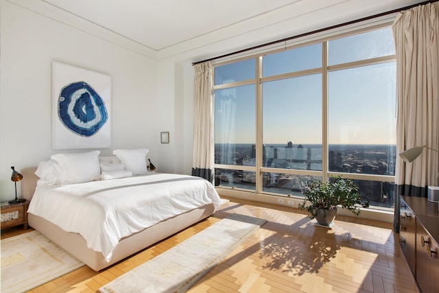 bedroom with ornamental molding and a city view