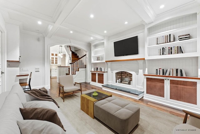 living room with coffered ceiling, built in features, beam ceiling, and light wood-type flooring