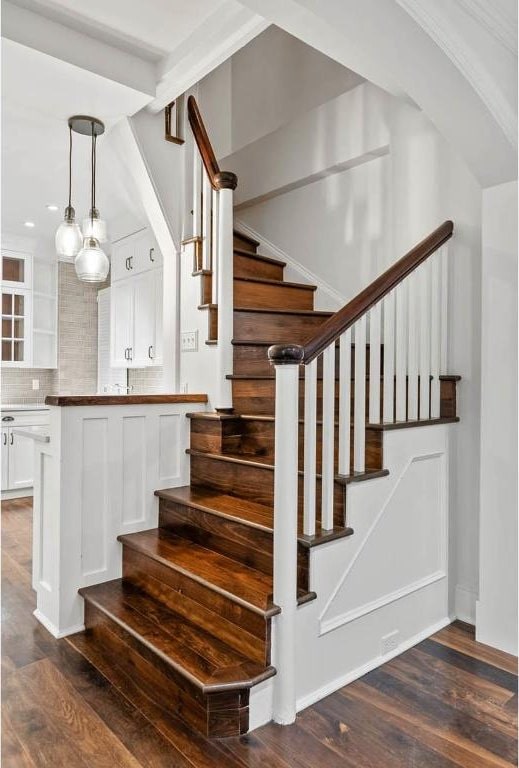 stairs featuring wood finished floors