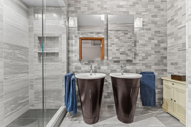 60 W 68th St Unit 5-Bc, New York City, NY 10023 - bathroom featuring tile walls, a stall shower, and two vanities