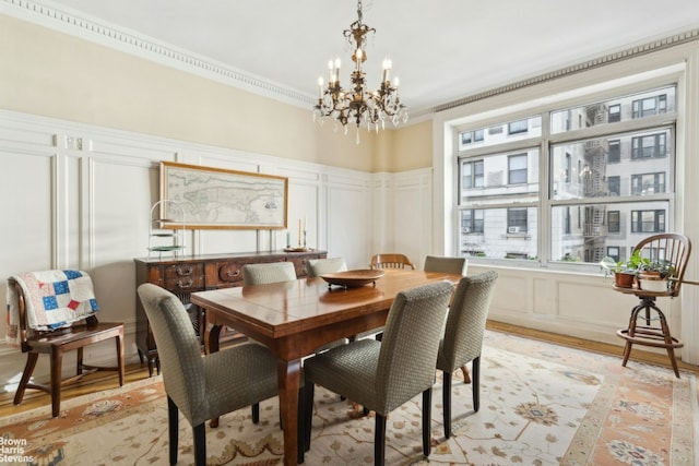 dining area featuring crown molding and a notable chandelier