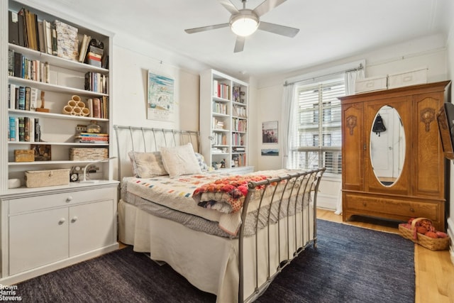 bedroom with ceiling fan and dark wood-type flooring