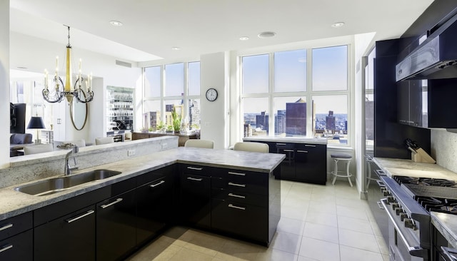 kitchen featuring a sink, dark cabinets, ventilation hood, high end stove, and light tile patterned flooring