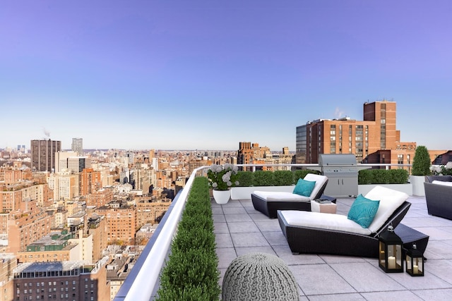 view of patio / terrace with a view of city, a balcony, and area for grilling