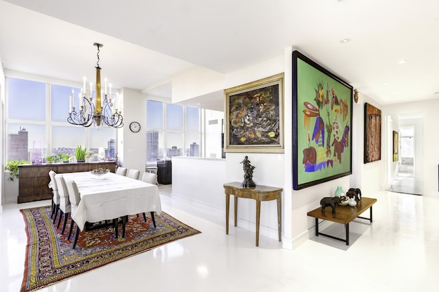 dining space with a chandelier, a skyline view, and baseboards