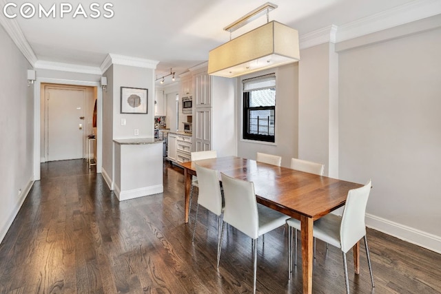 dining space with dark hardwood / wood-style floors and crown molding