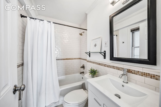 bathroom featuring shower / bath combo with shower curtain, tile walls, toilet, ornamental molding, and vanity