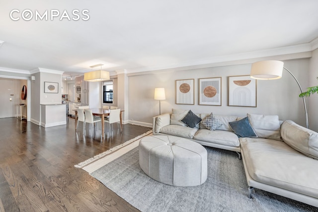 living room featuring ornamental molding, dark wood-type flooring, and baseboards