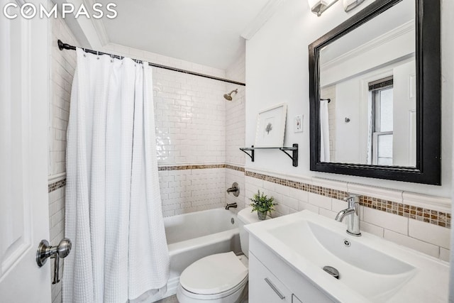 full bathroom featuring vanity, tile walls, toilet, ornamental molding, and shower / bath combo