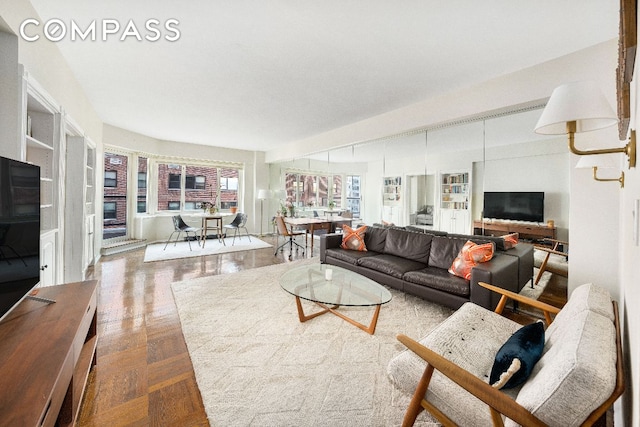 living room featuring hardwood / wood-style floors and built in features