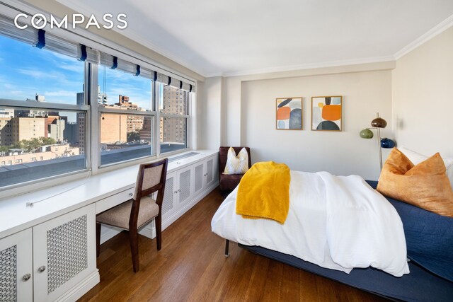 bedroom featuring crown molding and hardwood / wood-style flooring