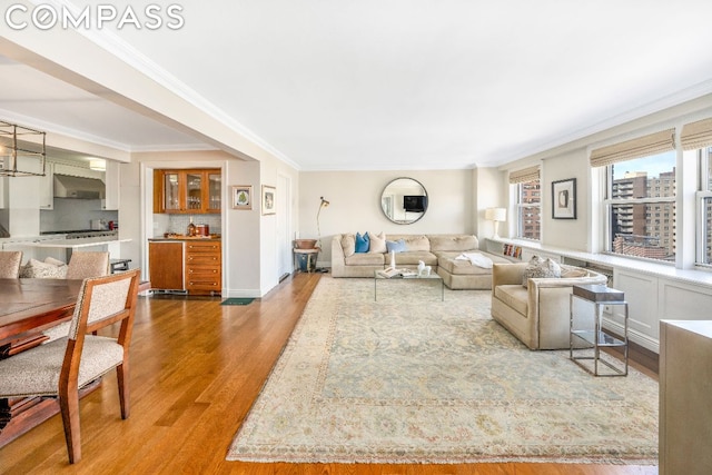 living room featuring hardwood / wood-style flooring and crown molding