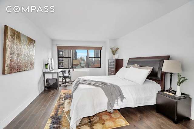 bedroom with wood finished floors and baseboards