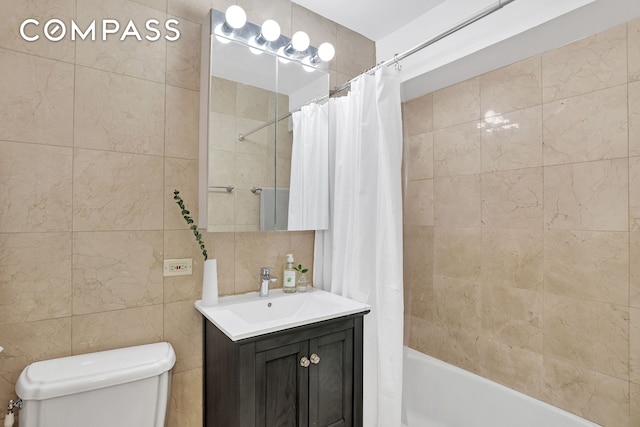 full bathroom featuring shower / tub combo, vanity, toilet, and tile walls