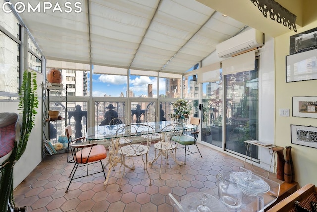 sunroom / solarium with an AC wall unit and vaulted ceiling