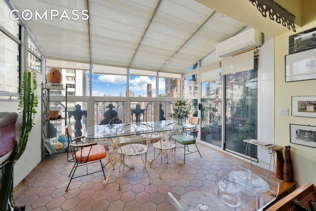 sunroom / solarium featuring a view of city, a wall mounted air conditioner, and vaulted ceiling