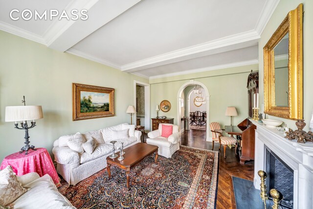 living room with dark parquet floors and ornamental molding