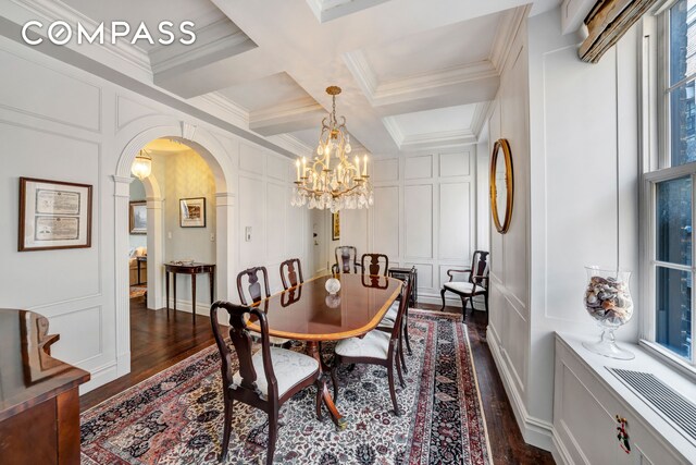 dining area with dark wood-type flooring, a healthy amount of sunlight, a chandelier, beam ceiling, and coffered ceiling