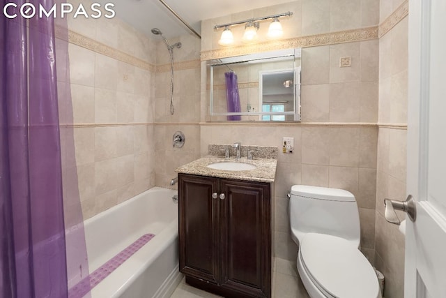 full bathroom featuring toilet, vanity, tile walls, and shower / bath combo with shower curtain