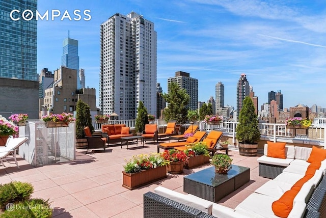 view of patio / terrace with an outdoor living space and a city view