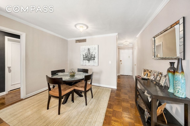 dining space with parquet floors and ornamental molding