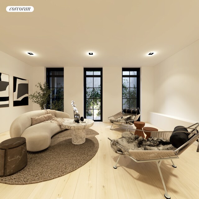 living room featuring a premium fireplace and light hardwood / wood-style floors