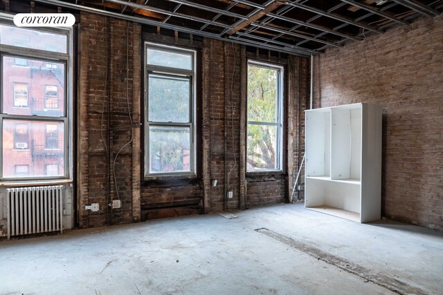 bedroom with a wall of windows and access to exterior