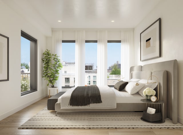 bedroom featuring recessed lighting, baseboards, multiple windows, and light wood finished floors