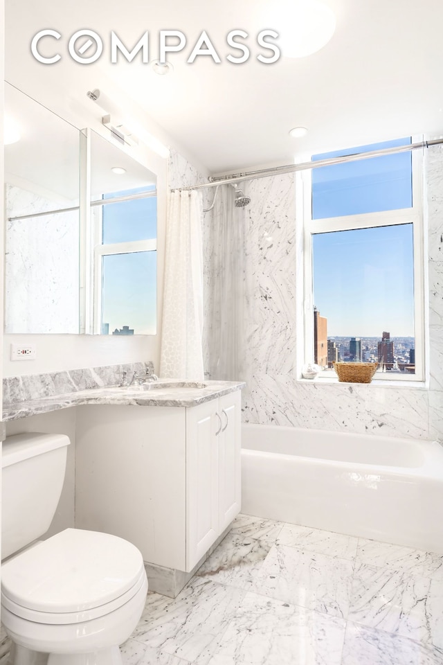 full bathroom with toilet, plenty of natural light, marble finish flooring, and vanity