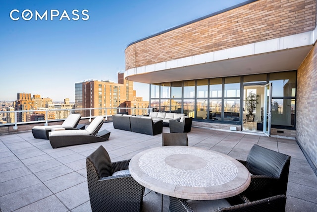 view of patio / terrace with outdoor lounge area and a view of city