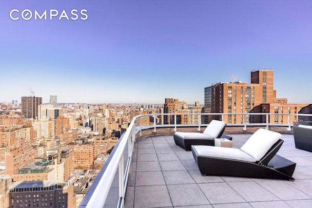 view of patio / terrace featuring a balcony and a city view
