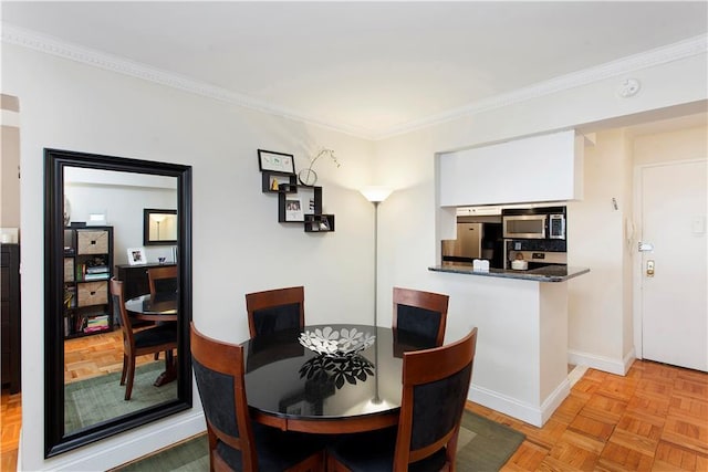 dining area with light parquet flooring and ornamental molding