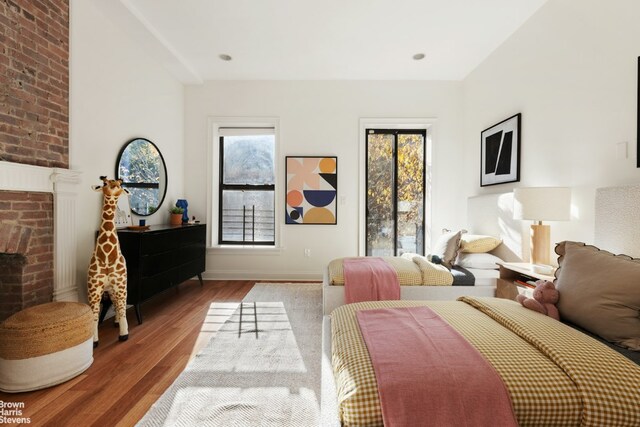 bedroom with light wood-type flooring and access to outside