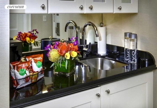 kitchen with sink, white cabinetry, and tasteful backsplash