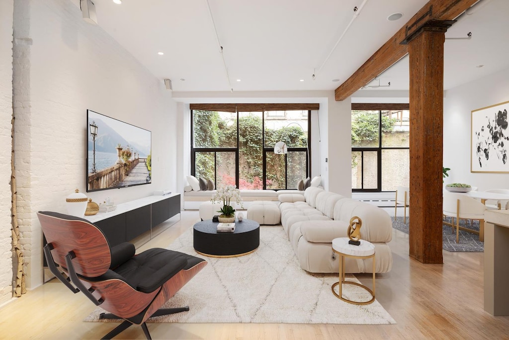 living room with wood finished floors, decorative columns, and recessed lighting