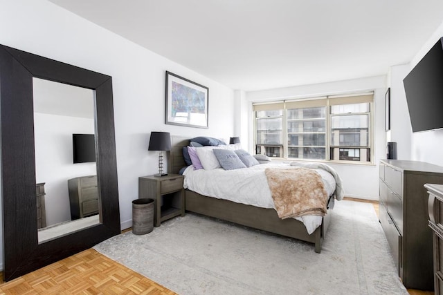 bedroom with light parquet floors