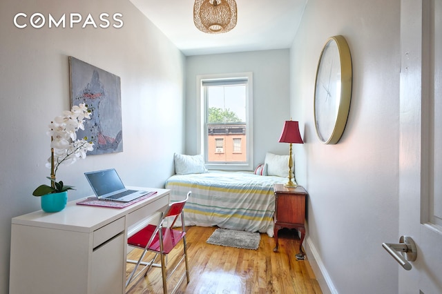 bedroom with baseboards and light wood-style floors