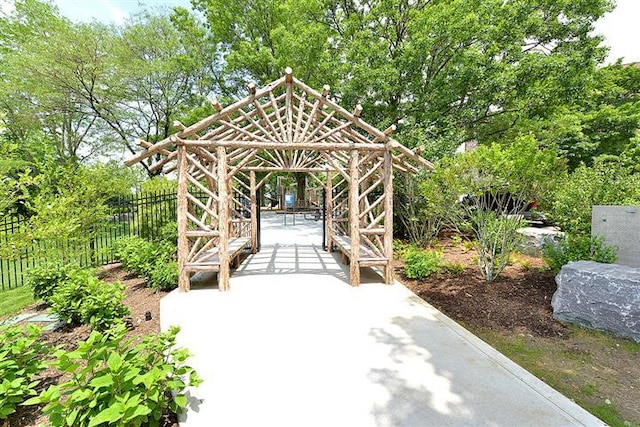 view of home's community featuring a gazebo, a patio, and fence