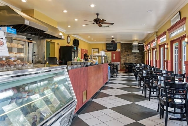 kitchen with wall chimney range hood, tile patterned flooring, ornamental molding, and recessed lighting