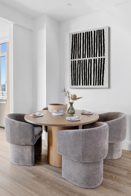 dining space featuring wood-type flooring