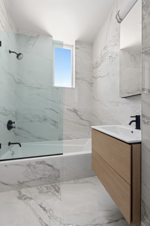 bathroom with vanity and tiled shower / bath combo