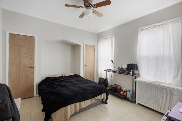 bedroom featuring radiator and ceiling fan