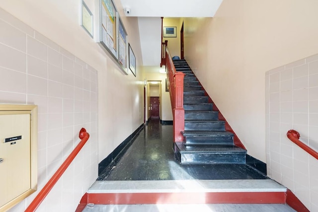 staircase with tile walls