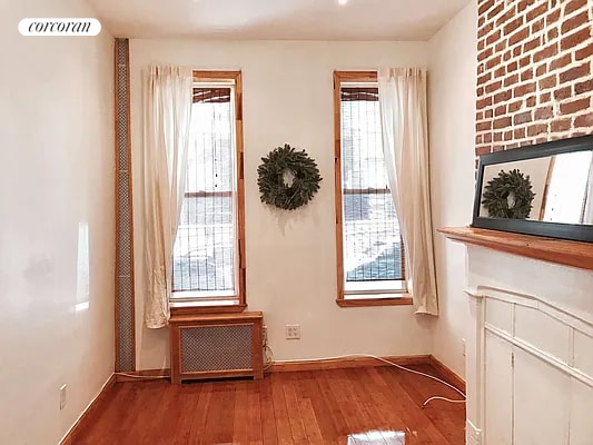 doorway with radiator, wood-type flooring, and plenty of natural light