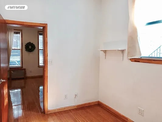 unfurnished room with hardwood / wood-style flooring