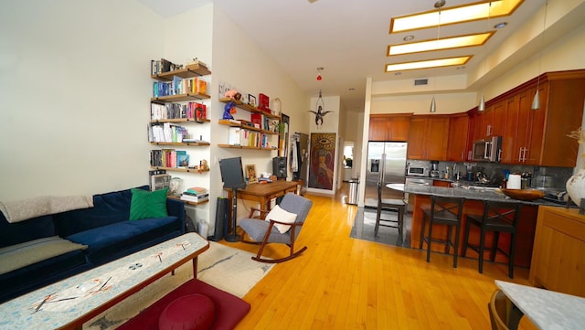 living area with light wood-type flooring and visible vents