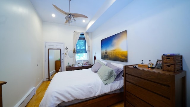 bedroom with light wood-style flooring, a baseboard heating unit, recessed lighting, baseboards, and ceiling fan